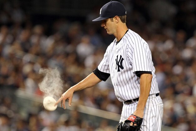 Jul 21, 2014; Bronx, NY, USA; New York Yankees starting pitcher Shane Greene (61) uses a rosin bag against the Texas Rangers during the sixth inning at Yankee Stadium. Mandatory Credit: Adam Hunger-USA TODAY Sports