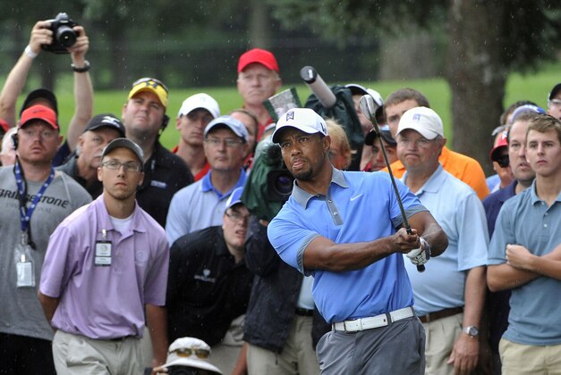 Tiger Woods hits his third shot and his second from the rough at the 18th hole during the second round, at the WGC Bridgestone Invitational golf tournament, at Firestone Country Club in Akron, Ohio, Friday, Aug. 2,  2013. Woods parred the hole, shot a nine-under par 61 and tied the tournament single-round record. (AP Photo/Phil Long)