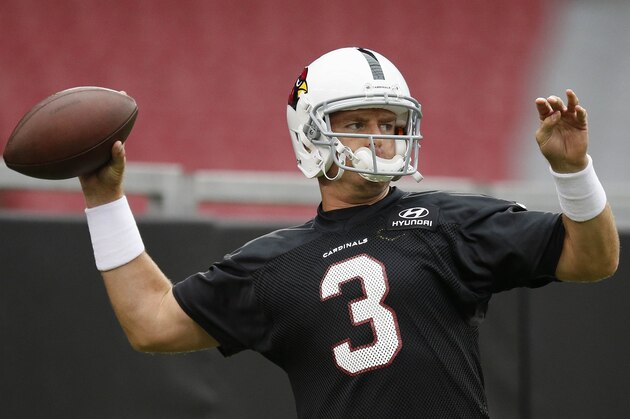 Arizona Cardinals' Carson Palmer throws a pass during the first day of NFL football training camp on Saturday, July 26, 2014, in Glendale, Ariz. (AP Photo/Ross D. Franklin)