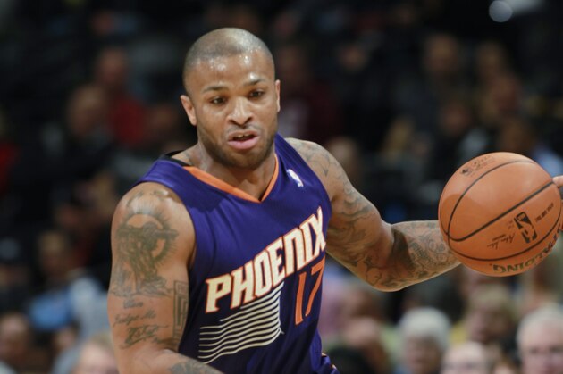 Phoenix Suns forward P.J. Tucker picks up loose ball against the Denver Nuggets in the first quarter of an NBA basketball game in Denver on Tuesday, Feb. 18, 2014. (AP Photo/David Zalubowski)