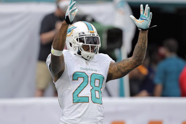 Miami Dolphins cornerback Nolan Carroll (28) stretches before an NFL football game against the New York Jets Sunday, Dec. 29, 2013, in Miami Gardens, Fla. (AP Photo/Chris O'Meara)