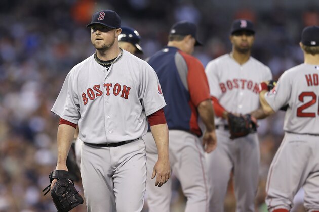 Boston Red Sox starting pitcher Jon Lester heads to the dugout after being removed during the fifth inning of a baseball game against the Detroit Tigers in Detroit, Saturday, June 7, 2014. (AP Photo/Carlos Osorio)