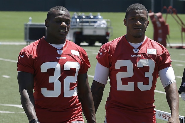 San Francisco 49ers running back Kendall Hunter (32) and running back LaMichael James (23) walk off the practice field during NFL football mini-camp in Santa Clara, Calif., Wednesday, June 18, 2014. (AP Photo/Jeff Chiu)