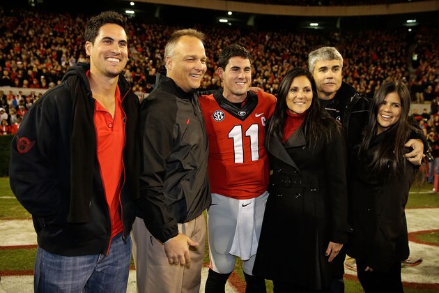 ATHENS, GA - NOVEMBER 23:  Quarterback Aaron Murray #11 of the Georgia Bulldogs poses with his family and Georgia head coach Mark Richt second from left) during Senior Day festivities before the game against the Kentucky Wildcats at Sanford Stadium on November 23, 2013 in Athens, Georgia.  (Photo by Mike Zarrilli/Getty Images)