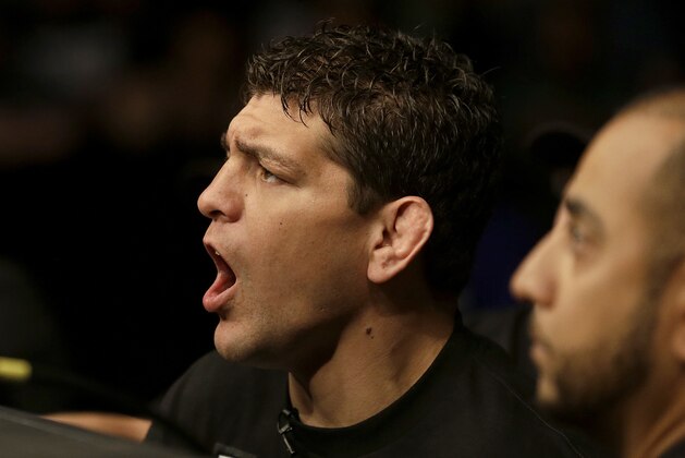 Nick Diaz, left, cheers on his brother Nate Diaz during a UFC lightweight mixed martial arts fight between Nate Diaz and Josh Thomson in San Jose, Calif., Saturday, April 20, 2013. Thomson won by technical knock out in the second round. (AP Photo/Jeff Chiu)