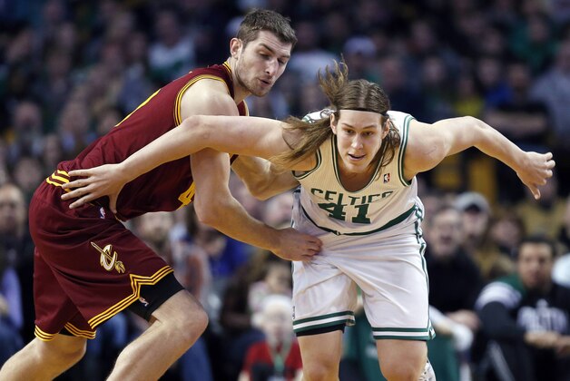 Boston Celtics' Kelly Olynyk (41) and Cleveland Cavaliers' Tyler Zeller (40) chase a loose ball in the third quarter of an NBA basketball game in Boston, Saturday, Dec. 28, 2013. The Celtics won 103-100. (AP Photo/Michael Dwyer)