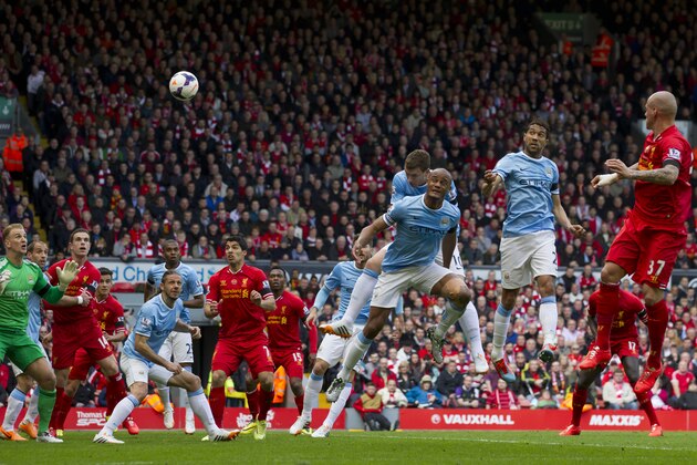 Liverpool's Martin Skrtel, right, scores against Manchester City during their English Premier League soccer match at Anfield Stadium, Liverpool, England, Sunday April 13, 2014. (AP Photo/Jon Super)