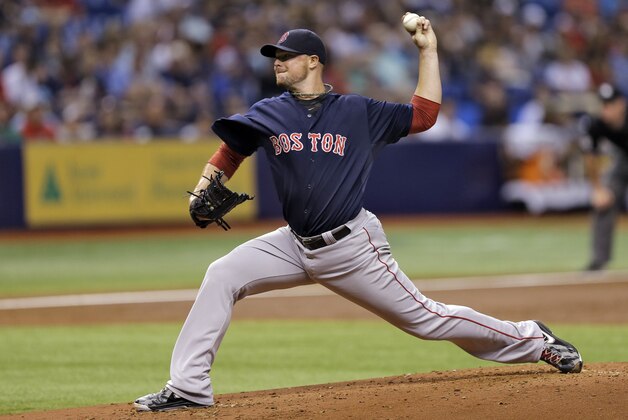Boston Red Sox starting pitcher Jon Lester delivers to the Tampa Bay Rays during the third inning of a baseball game Friday, July 25, 2014, in St. Petersburg, Fla. (AP Photo/Chris O'Meara)