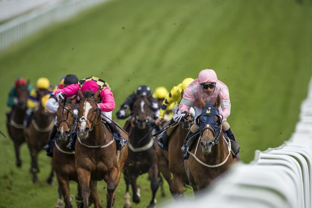 EPSOM, ENGLAND - APRIL 23:  Silvestre De Sousa riding Sennockian Star (R) wins the Investec Property Investments City And Suburban Handicap at Epsom Racecourse on April 23, 2014 in Epsom, England.  (Photo by Justin Setterfield/Getty Images)