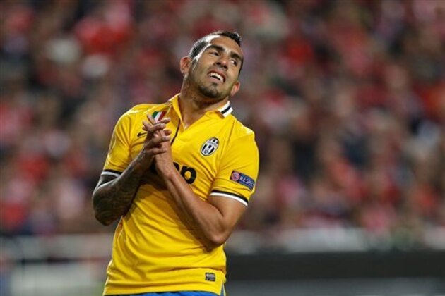 FILE - In this April 24, 2014 file photo, Juventus' Carlos Tevez reacts after missing a chance to score during a Europa League soccer semifinal at Benfica's Luz Stadium in Lisbon, Portugal. Tevez's father was kidnapped after his vehicle was intercepted Tuesday, July 29, 2014, outside Argentina's capital Buenos Aires, said the footballer's lawyer, Gustavo Galasso. (AP Photo/Armando Franca, File)