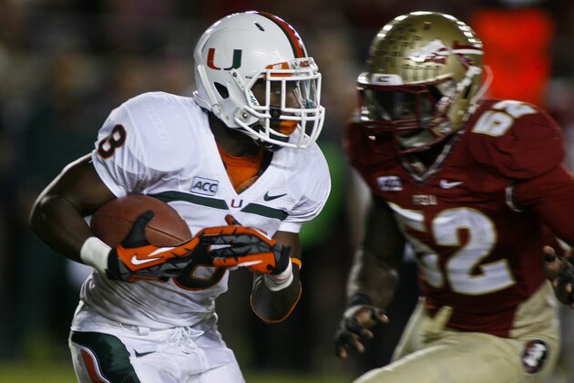 Miami running back Duke Johnson (8) returns a kickoff past Florida State linebacker Ukeme Eligwe (52) in the first quarter of an NCAA college football game Saturday, Nov. 2, 2013, in Tallahassee, Fla. Florida State beat Miami 41-14. (AP Photo/Phil Sears)