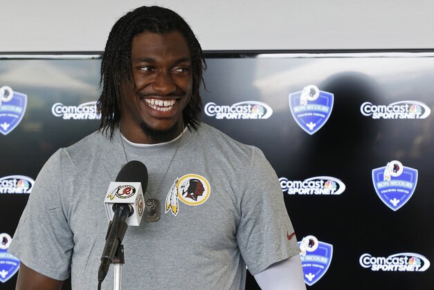 Jul 24, 2014; Richmond, VA, USA; Washington Redskins quarterback Robert Griffin III (10) speaks with the media after practice on day one of training camp at Bon Secours Washington Redskins Training Center. Mandatory Credit: Geoff Burke-USA TODAY Sports