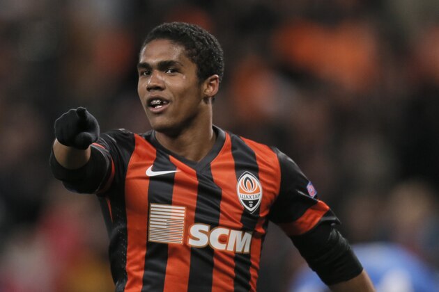 Shakhtar Donetsk's Douglas Costa  celebrates after scoring during the Champions League group A soccer match between Real Sociedad and FC Shakhtar Donetsk at the Donbas Arena stadium in Donetsk, Ukraine, Ukraine, Wednesday, Nov. 27, 2013. (AP Photo/Efrem Lukatsky)