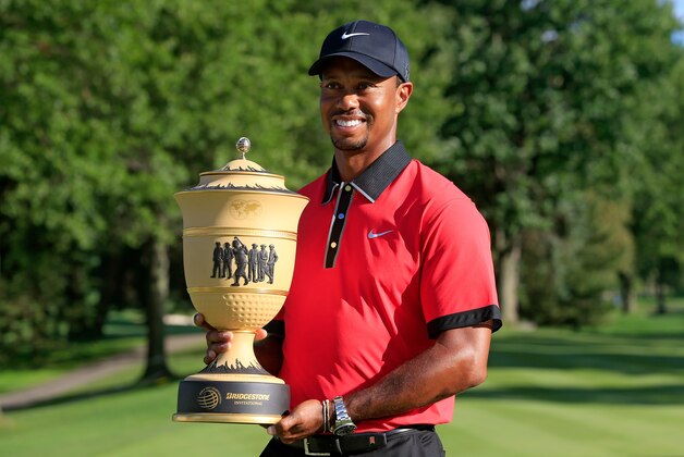 AKRON, OH - AUGUST 04:  Tiger Woods holds the Gary Player Cup trophy after the Final Round of the World Golf Championships-Bridgestone Invitational at Firestone Country Club South Course on August 4, 2013 in Akron, Ohio. Woods won the tournament with a score of -15.  (Photo by Sam Greenwood/Getty Images)