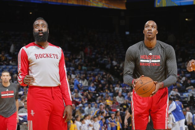 OAKLAND, CA - DECEMBER 13: James Harden #13 and Dwight Howard #12 of the Houston Rockets warm up prior to the game against the Golden State Warriors on December 13, 2013 at Oracle Arena in Oakland, California. NOTE TO USER: User expressly acknowledges and agrees that, by downloading and or using this photograph, user is consenting to the terms and conditions of Getty Images License Agreement. Mandatory Copyright Notice: Copyright 2013 NBAE (Photo by Rocky Widner/NBAE via Getty Images)