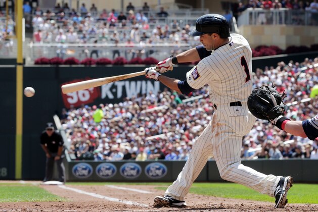 Minnesota Twins' Sam Fuld  drives in a run with a single off Cleveland Indians pitcher Trevor Bauer in the third inning of a baseball game, Wednesday, July 23, 2014, in Minneapolis. (AP Photo/Jim Mone)