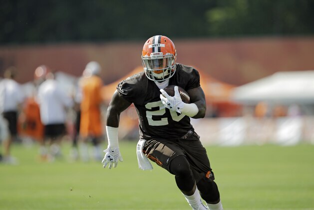 Cleveland Browns running back Terrance West runs the ball at the NFL football team's training camp in Berea, Ohio Saturday, July 26, 2014. (AP Photo/Mark Duncan)