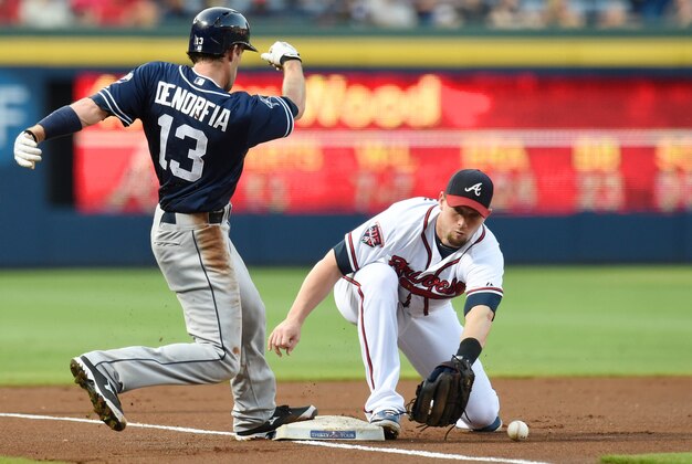 Jul 25, 2014; Atlanta, GA, USA; San Diego Padres center fielder Chris Denorfia (13) runs back to third base while Atlanta Braves third baseman Chris Johnson (23) stops the throw from the outfield during the first inning at Turner Field. Mandatory Credit: Dale Zanine-USA TODAY Sports