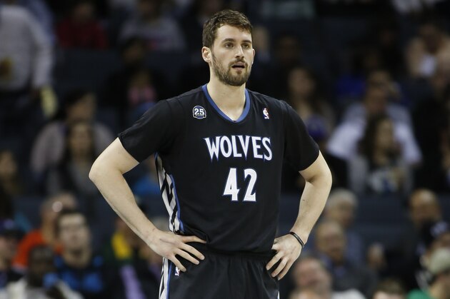 Minnesota Timberwolves forward Kevin Love stands on the court as his team plays against the Charlotte Bobcats during the first half of an NBA basketball game in Charlotte, N.C., Friday, March 14, 2014. (AP Photo/Nell Redmond)