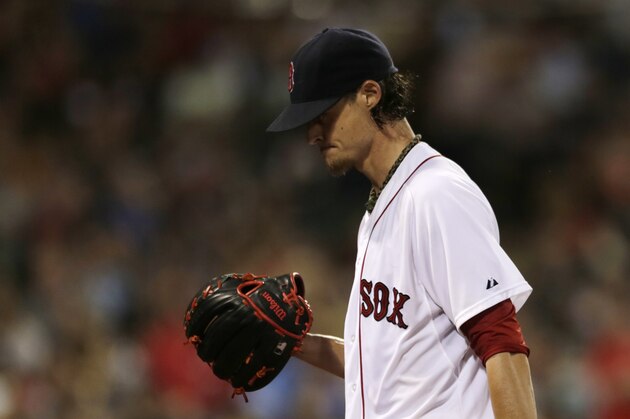 Boston Red Sox starting pitcher Clay Buchholz heads to the dugout as he is removed during the sixth inning of a baseball game at Fenway Park in Boston, Monday, July 28, 2014. (AP Photo/Charles Krupa)