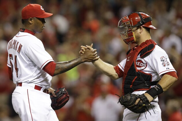 Cincinnati Reds relief pitcher Aroldis Chapman (54) is congratulated by catcher Devin Mesoraco after the Reds defeated the Arizona Diamondbacks 3-0 in a baseball game, Tuesday, July 29, 2014, in Cincinnati. Chapman earned his 23rd save. Chapman extended his streak of at least one strikeout in 45 consecutive appearances, a major league record for a reliever. (AP Photo/Al Behrman)