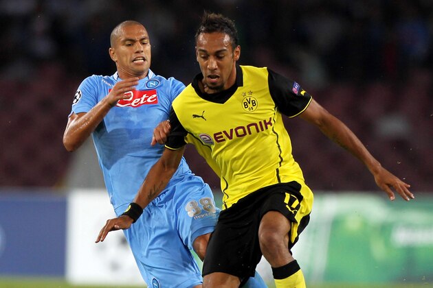 NAPLES, ITALY - SEPTEMBER 18: Pierre- Emerick Aubameyang (R) of Borussia Dortmund competes for the ball with Gokhan Inler of SSC Napoli during the Uefa Champions League Group F match between Napoli and Borussia Dortmund at Stadio San Paolo on September 18, 2013 in Naples, Italy.  (Photo by Paolo Bruno/Getty Images)