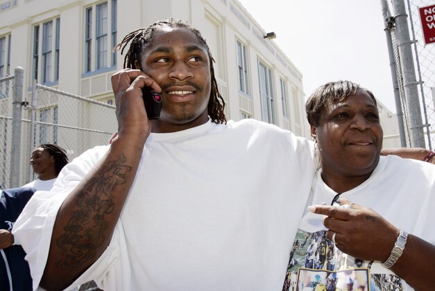 California running back Marshawn Lynch is hugged by his mother DeLisa Lynch, right, at his former high school, Oakland Technical High School, in Oakland, Calif., Saturday, April 28, 2007, after he was picked by the Buffalo Bills  as the No. 12 pick overall in the NFL football draft. (AP Photo/Paul Sakuma)