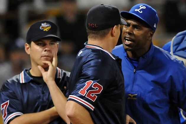 Jose Offerman, right, manager of the Dominican Republic winter league team Licey Tigers, argues with plate umpire Jason Bradley, as first base umpire Daniel Rayburn, left, looks on, during a playoff series game against Cibao Giants in Santo Domingo, Saturday, Jan. 16, 2010. Offerman, a former major league All-Star, threw a punch at Rayburn during the argument, the second time in two and a half years that he's attacked someone on a baseball field. (AP Photo/Victor Calvo)