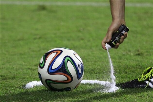 A referee uses vanishing spray during a referee's training session in Rio de Janeiro, Brazil, Friday, June 6, 2014. Referees will use vanishing spray during 2014 World Cup to stop defensive walls creeping forward at free-kicks. The international soccer tournament is set to begin in a few days, with Brazil and Croatia competing in the opening match on June 12. (AP Photo/Hassan Ammar)