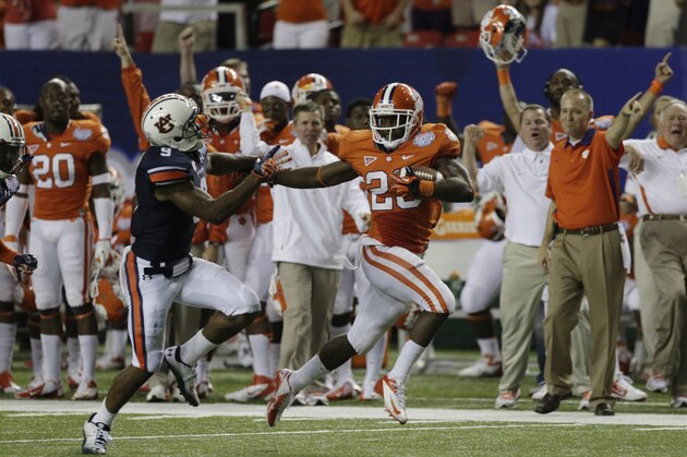 Clemson running back Andre Ellington (23) puts a stiff arm on Auburn defensive back Jermaine Whitehead (9) as he runs for a first down in the second half of a NCAA college football game at the Georgia Dome in Atlanta Saturday, Sept. 1, 2012. Clemson beat Auburn 26-19. (AP Photo/Dave Martin)