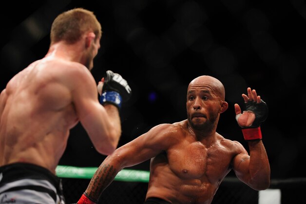 Jun 14, 2014; Vancouver, British Columbia, Canada; Demetrious Johnson (red) fights Ali Bagautinov (blue) in the Flyweight Title bout at UFC 174 at Rogers Arena. Demetrious Johnson defeats Ali Bagautinov via unanimous decision. Mandatory Credit: Anne-Marie Sorvin-USA TODAY Sports