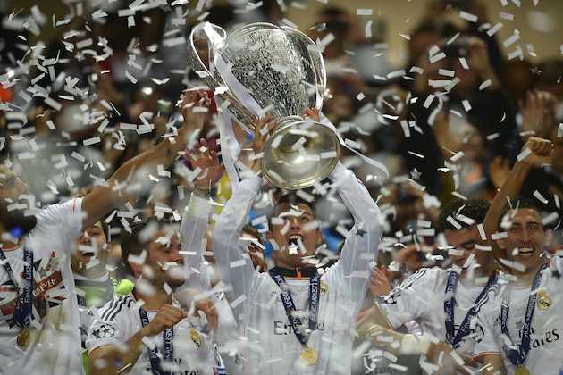 Real's Cristiano Ronaldo, centre, lifts the Champion League trophy, at the end of the Champions League final soccer match between Atletico Madrid and Real Madrid, at the Luz stadium, in Lisbon, Portugal, Saturday, May 24, 2014. (AP Photo/Manu Fernandez)