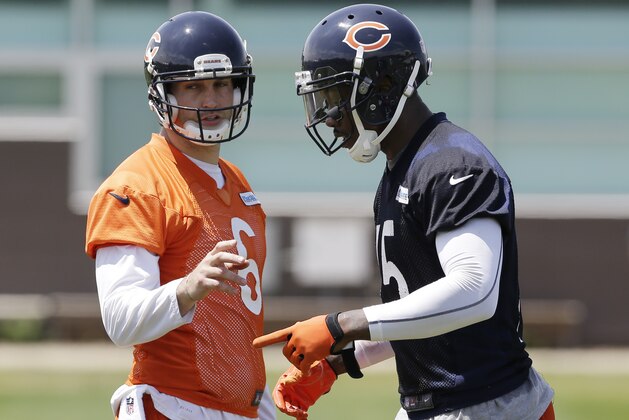 Chicago Bears quarterback Jay Cutler (6), left, talks with wide receiver Brandon Marshall (15) during an NFL football practice in Lake Forest, Ill., Tuesday, May 27, 2014. (AP Photo/Nam Y. Huh)