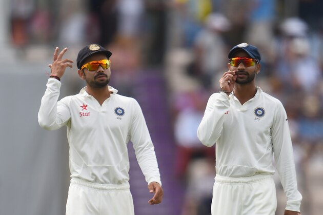 SOUTHAMPTON, ENGLAND - JULY 27:  Virat Kohli and Shikhar Dhawan of India talk as they walk out onto the pitch for the second session during Day 1 of the 3rd Investec Test match between England and India at the Ageas Bowl on July 27, 2014 in Southampton, England.  (Photo by Christopher Lee/Getty Images)