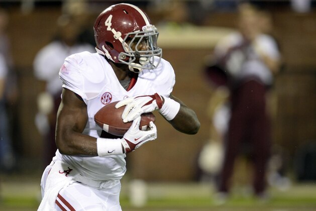 Nov 16, 2013; Starkville, MS, USA; Alabama Crimson Tide running back T.J. Yeldon (4) carries against the Mississippi State Bulldogs during the first quarter at Davis Wade Stadium. Mandatory Credit: John David Mercer-USA TODAY Sports