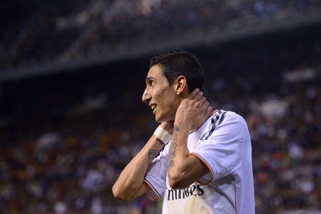 Real's Angel Di Maria smiles during the final of the Copa del Rey between FC Barcelona and Real Madrid at the Mestalla stadium in Valencia, Spain, Wednesday, April 16, 2014. (AP Photo/Manu Fernandez)