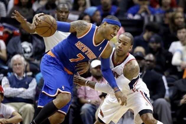New York Knicks' Carmelo Anthony, left, dribbles the ball against the defense of Atlanta Hawks' Dahntay Jones in the second quarter of an NBA basketball game, Wednesday, April 3, 2013, in Atlanta. (AP Photo/David Goldman)