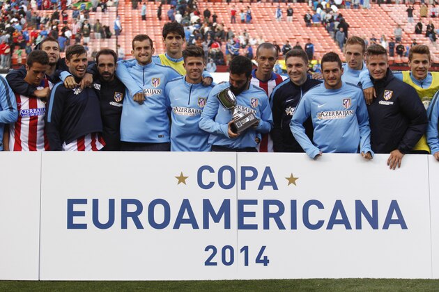 Athletico de Madrid poses with the winner's trophy after defeating the San Jose Earthquakes Sunday, July 27, 2014, in San Francisco. (AP Photo/Beck Diefenbach)