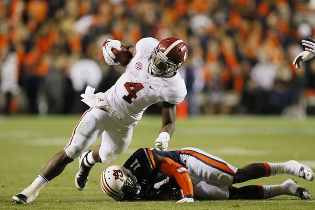 AUBURN, AL - NOVEMBER 30:  T.J. Yeldon #4 of the Alabama Crimson Tide tries to avoid the tackle of Chris Davis #11 of the Auburn Tigers in the third quarter at Jordan-Hare Stadium on November 30, 2013 in Auburn, Alabama.  (Photo by Kevin C. Cox/Getty Images)