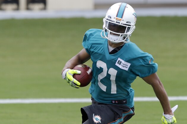 Miami Dolphins cornerback Brent Grimes (21) runs the ball during NFL football training camp in Davie, Fla., Saturday, July 26, 2014. (AP Photo/Alan Diaz)