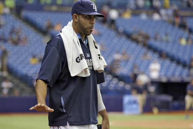 Tampa Bay Rays starting pitcher David Price waves to fans as he heads for the bullpen before a scheduled start against the Milwaukee Brewers in an interleague baseball game Wednesday, July 30, 2014, in St. Petersburg, Fla. Price has been the subject of trade rumors. (AP Photo/Chris O'Meara)