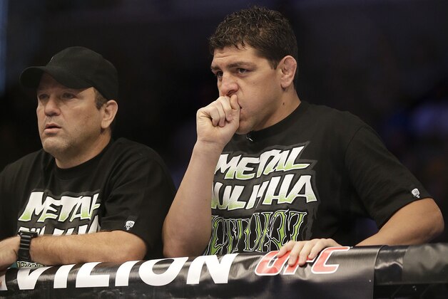 Nick Diaz, right, and Cesar Gracie stand in the corner of Nate Diaz before a UFC lightweight mixed martial arts fight between Nate Diaz and Josh Thomson in San Jose, Calif., Saturday, April 20, 2013. (AP Photo/Jeff Chiu)