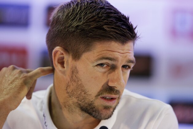 England national soccer team captain Steven Gerrard answers a question from a member of the media during a press conference after a squad training session that was closed to the media for the 2014 soccer World Cup at the Urca military base in Rio de Janeiro, Brazil, Sunday, June 22, 2014.  Costa Rica's surprise 1-0 win over Italy on Friday meant that England made its most humiliating exit from a World Cup since 1958, following consecutive defeats by the Italians and then Uruguay in Group D.  England play Costa Rica in their final Group D match on Tuesday.  (AP Photo/Matt Dunham)