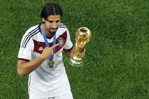 Germany's Sami Khedira points at the trophy after winning the World Cup final soccer match between Germany and Argentina at the Maracana Stadium in Rio de Janeiro, Brazil, Sunday, July 13, 2014. Mario Goetze volleyed in the winning goal in extra time to give Germany its fourth World Cup title with a 1-0 victory over Argentina on Sunday. (AP Photo/Fabrizio Bensch, Pool) Germany's Sami Khedira points at the trophy after winning the World Cup final soccer match between Germany and Argentina at the Maracana Stadium in Rio de Janeiro, Brazil, Sunday, July 13, 2014. Mario Goetze volleyed in the winning goal in extra time to give Germany its fourth World Cup title with a 1-0 victory over Argentina on Sunday. (AP Photo/Fabrizio Bensch, Pool)