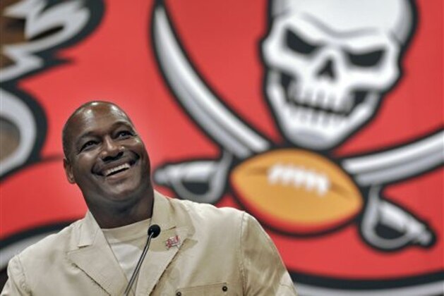 Former Tampa Bay Buccaneers linebacker Derrick Brooks smiles as he answers a question during a news conference Tuesday, May 6, 2014, in Tampa, Fla., after it was announced that he would be inducted into the team's Ring of Honor. Brooks played 14 season with the Buccaneers. (AP Photo/Chris O'Meara)