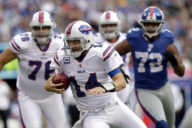New York Giants defensive end Osi Umenyiora (72) chases Buffalo Bills quarterback Ryan Fitzpatrick (14) with Bills offensive guard Chad Rinehart (76)  running alongside the play during the fourth quarter of an NFL football game  Sunday, Oct. 16, 2011, in East Rutherford, N.J.  (AP Photo/Kathy Willens)