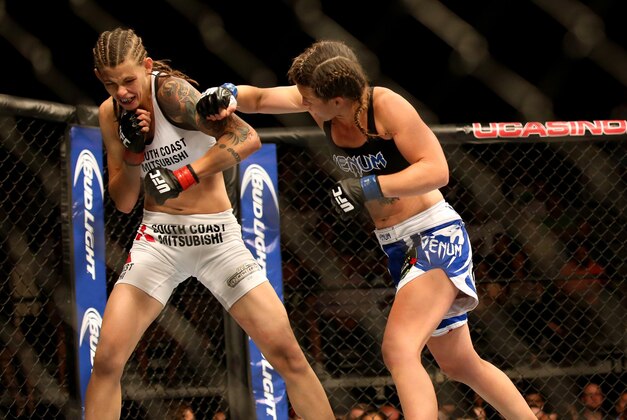 Jul 16, 2014; Atlantic City, NJ, USA; Leslie Smith throws a punch at Jessamyn Duke (red gloves) during a women's bantamweight bout at Revel Casino. Mandatory Credit: Bill Streicher-USA TODAY Sports