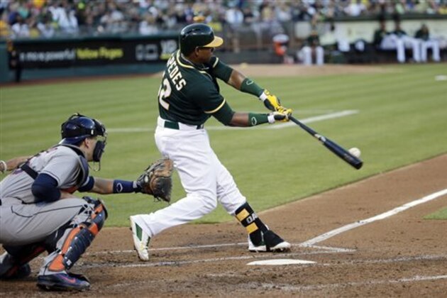 FILE - In this July 23, 2014 file photo, Oakland Athletics' Yoenis Cespedes hits a three-run home run against the Houston Astros during the second inning of a baseball game in Oakland, Calif. A person with knowledge of the trade says the Athletics have won the Jon Lester sweepstakes, acquiring the left-hander along with outfielder Jonny Gomes from the Red Sox for slugging outfielder Yoenis Cespedes before Thursday's, July 31, 2014,  trade deadline. The person spoke on condition of anonymity because neither club announced the deal. (AP Photo/File)