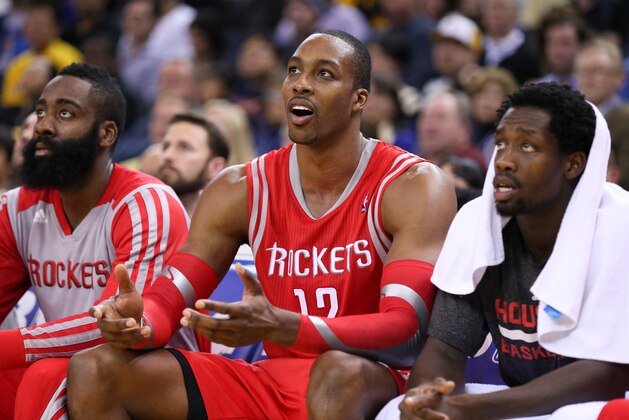 Dec 13, 2013; Oakland, CA, USA; Houston Rockets power forward Dwight Howard (12) on the bench between shooting guard James Harden (13) and point guard Patrick Beverley (2) against the Golden State Warriors during the fourth quarter at Oracle Arena. The Houston Rockets defeated the Golden State Warriors 116-112. Mandatory Credit: Kelley L Cox-USA TODAY Sports