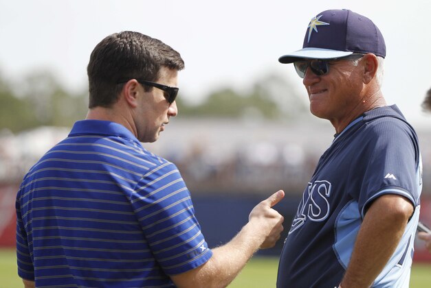 Mar 5, 2014; Port Charlotte, FL, USA; Tampa Bay Rays manager Joe Maddon (70) and VP of baseball operations Andrew Friedman talk prior to the game against the New York Yankees at Charlotte Sports Park. Mandatory Credit: Kim Klement-USA TODAY Sports
